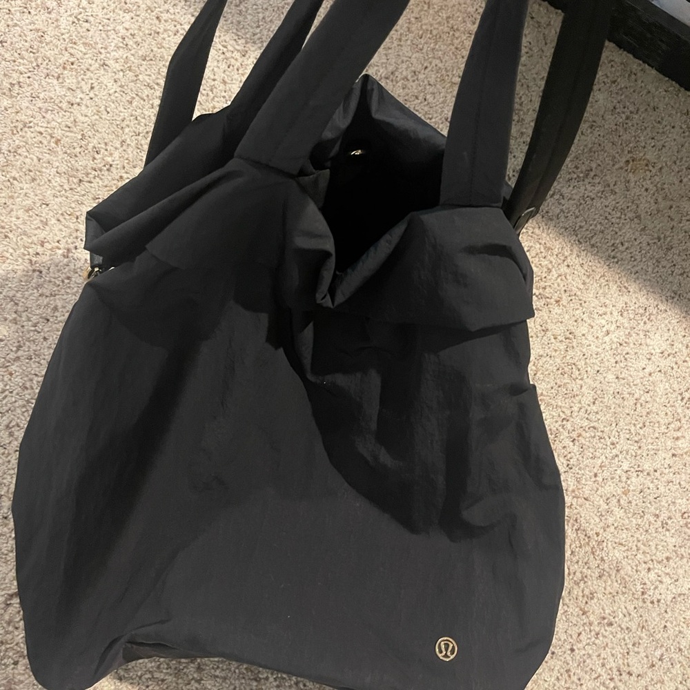 Lulu Lemon large tote with middle zipper compartment. Two handles one shoulder.